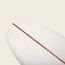 A close-up of a white longboard surfboard’s nose, featuring a single brown wooden stringer running down the center, highlighting the Surf Thumps versatile handling against a plain light background.