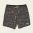 Patterned Bruja Boardshorts with a drawstring waist, featuring colorful dinosaurs and plants on a dark background with scattered dots. Stretchy fabric and draining front pockets add comfort and function. A Howler Bros patch is sewn near the bottom hem.