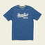 A blue short-sleeve t-shirt made from a soft cotton-poly blend, featuring the bold white Howler Bros logo across the chest. The shirt is laid flat on a light background, showcasing one of the classic Howler designs.