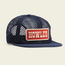 A navy blue mesh tech hat with a flat bill and a rectangular red patch reading HOWLER in white letters on the front. This versatile cover is displayed on a light beige background.