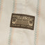 A fabric patch featuring a vintage Toyota Land Cruiser grille design and the text “Toyota Land Cruiser” and “Howler Brothers,” sewn onto a beige cloth with a pastel striped pattern, perfect for fans of vintage inspired shirts.