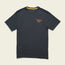 A dark gray short-sleeve t-shirt from the JT Van Zandt Collection, featuring a small, colorful geometric triangle design on the left chest, is displayed on a light, neutral background. Part of our Howler Select T-Shirts series.