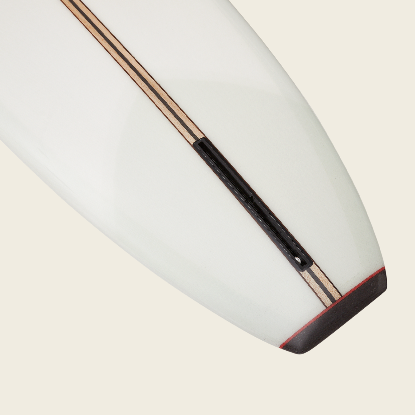 Close-up of the tail end of a traditional surfboard, featuring wood stringer details and a black fin box—this classic design is ideal for noseriding, inspired by the iconic Bing Noserider style. - View 4