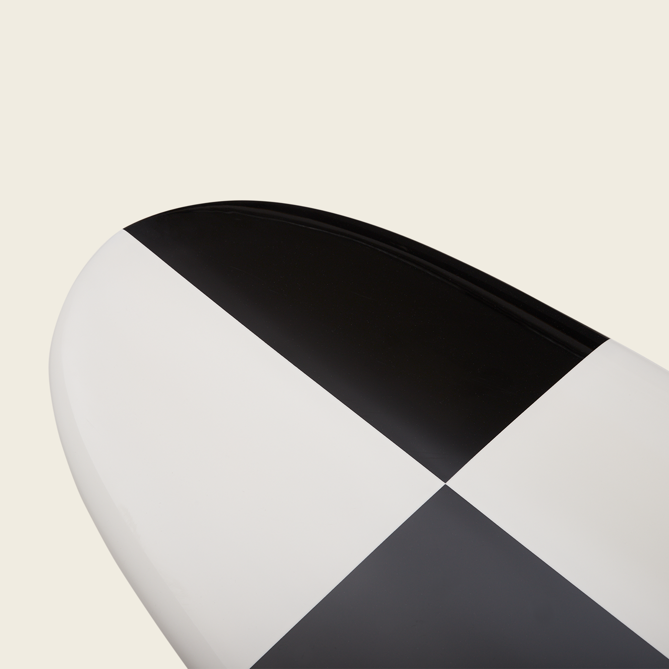 Close-up of the end of a traditional surfboard featuring a bold black and white checkered pattern on a plain, light background—perfect for classic noseriding style. - View 3