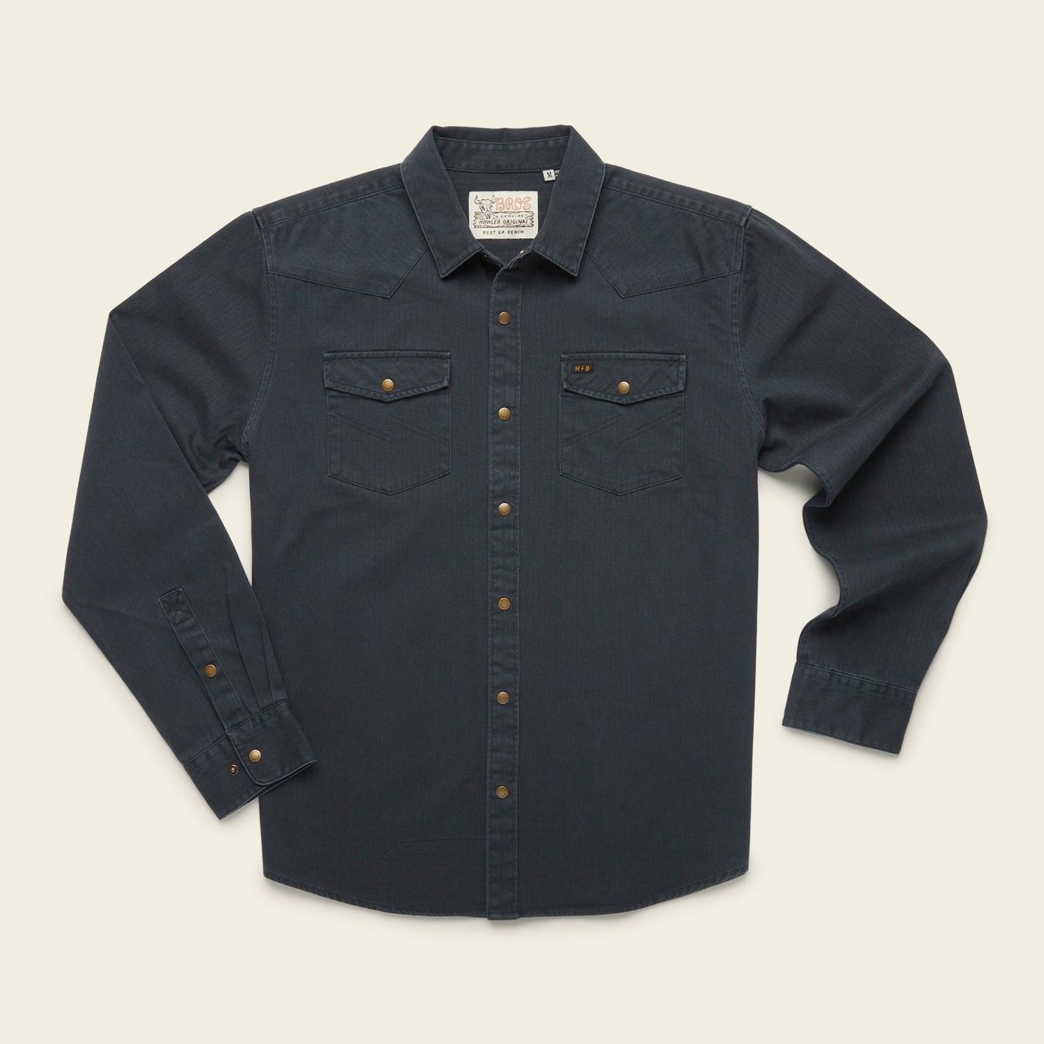 A rugged cotton Sawhorse Work Shirt in dark blue denim with long sleeves, front button closure, two flap chest pockets, and bronze-colored buttons, laid flat on a light background. - View 1