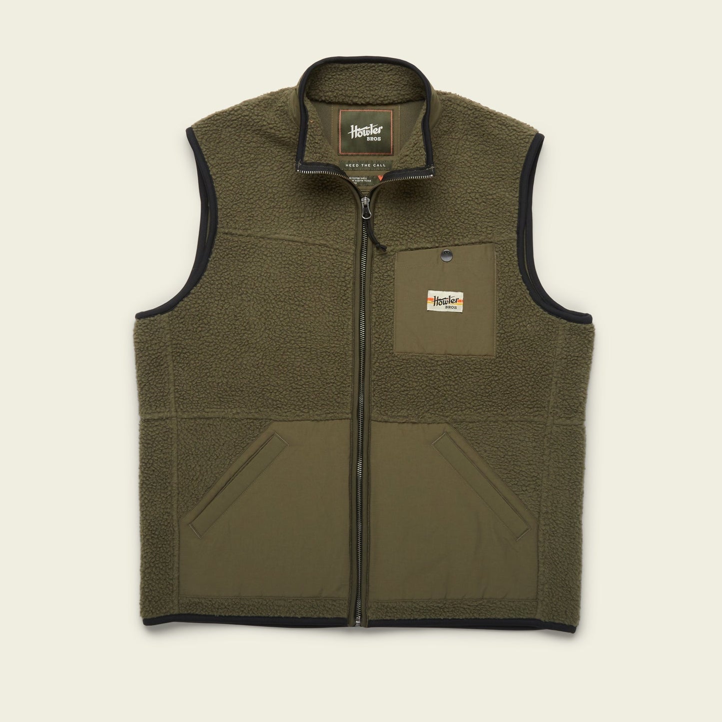 Olive green Chisos Fleece Vest made from high pile fleece; this lightweight vest features a full front zipper, two side pockets, a small chest pocket with Howler Bros label, and black trim along the edges. - View 9