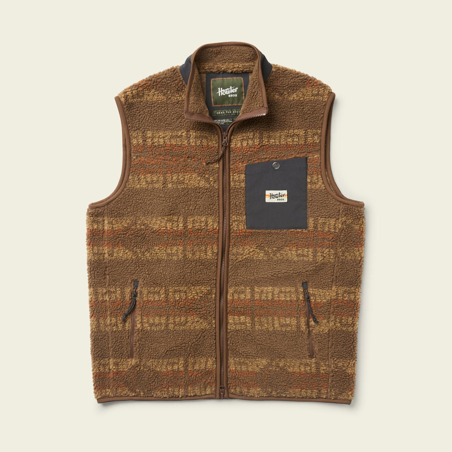 The Chisos Fleece Vest is a lightweight vest made from high pile fleece, featuring a plaid pattern, zip front, two zippered side pockets, and a dark chest pocket with the “Howler Bros” logo. - View 3