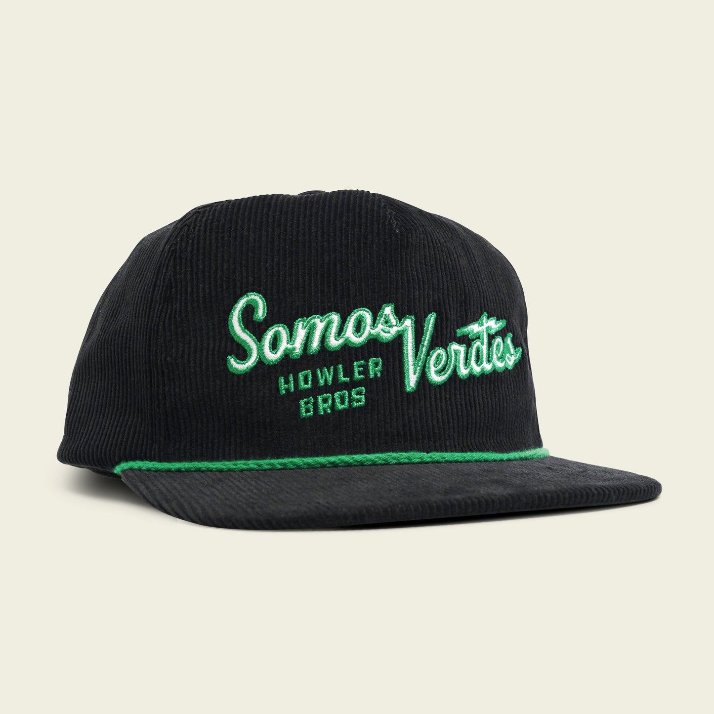 A black corduroy unstructured snapback baseball cap with green trim and embroidered text reading Somos Verdes and Howler Bros on the front, part of the 2024 Verde Collection inspired by Austin FC. The background is a light beige color. - View 1