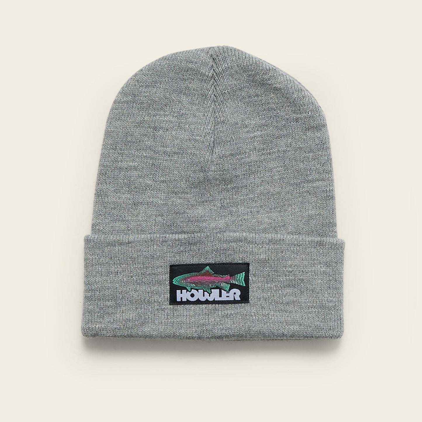 A gray knit beanie with a folded brim, featuring a patch of a colorful fish and the word Howler embroidered on the front. - View 5