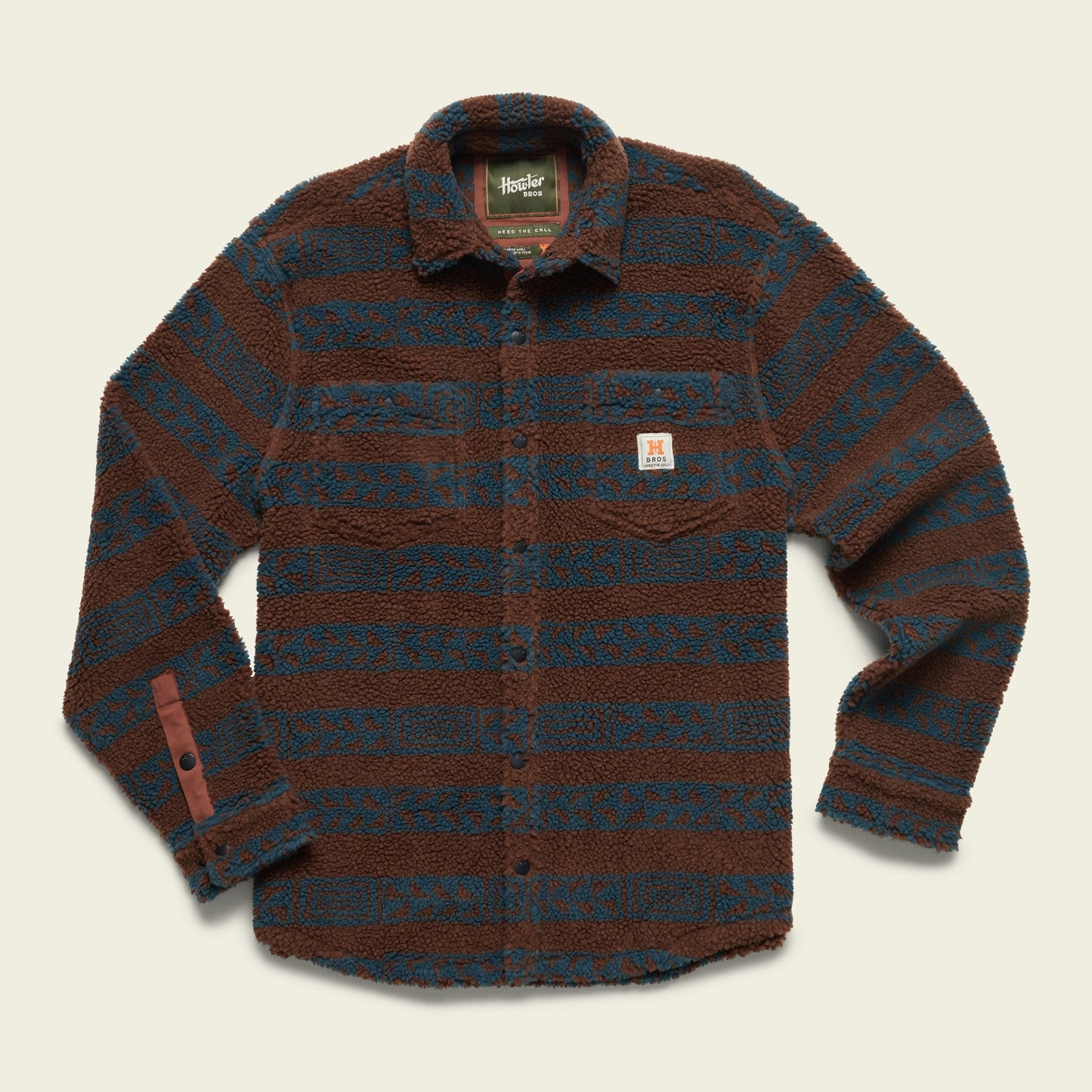 A long-sleeve fleece overshirt with a fuzzy, high pile fleece texture, featuring horizontal blue and brown stripes and a small patch on the chest pocket. The casual jacket has a collar and is laid flat on a light background. - View 4