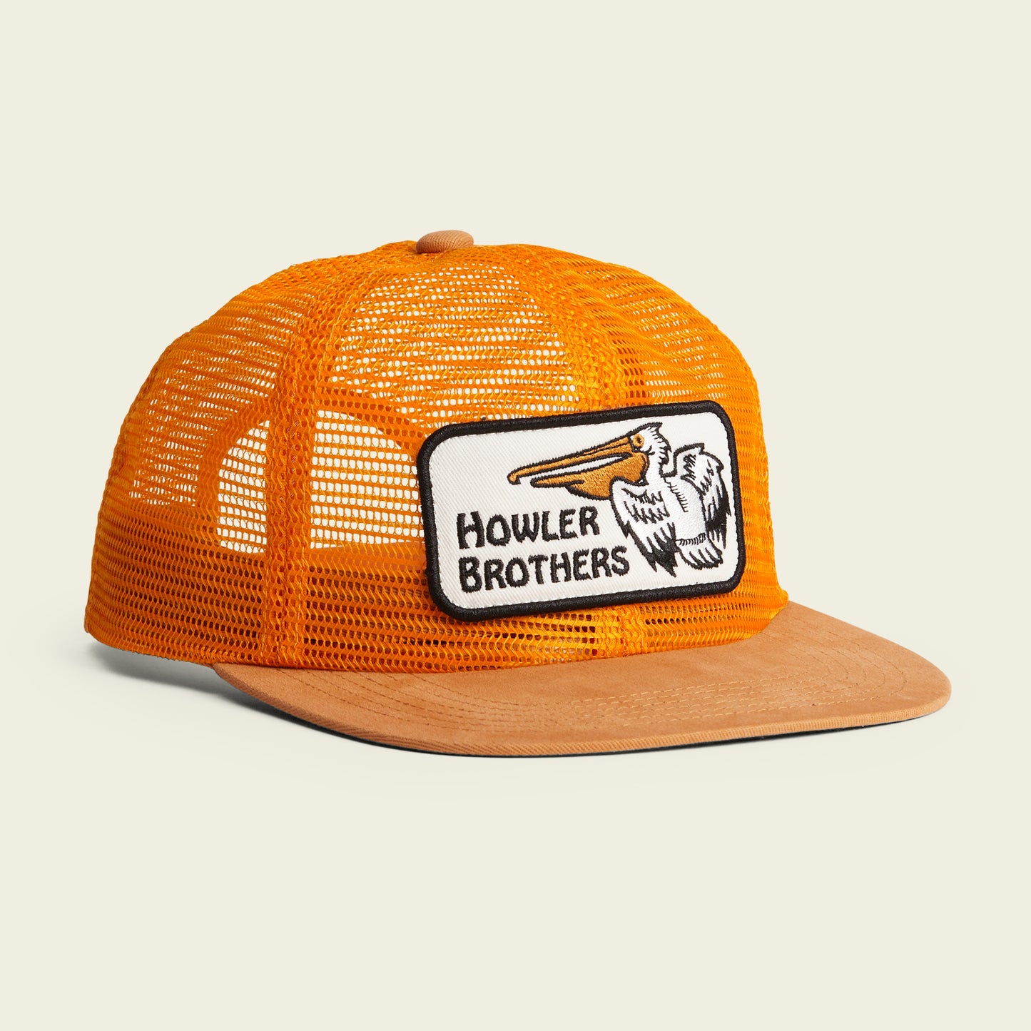 An orange mesh trucker hat with a tan suede brim, featuring a soft crown and a rectangular patch with a pelican illustration and Howler Brothers on the front. Finished with an adjustable snapback closure for the perfect fit. - View 2