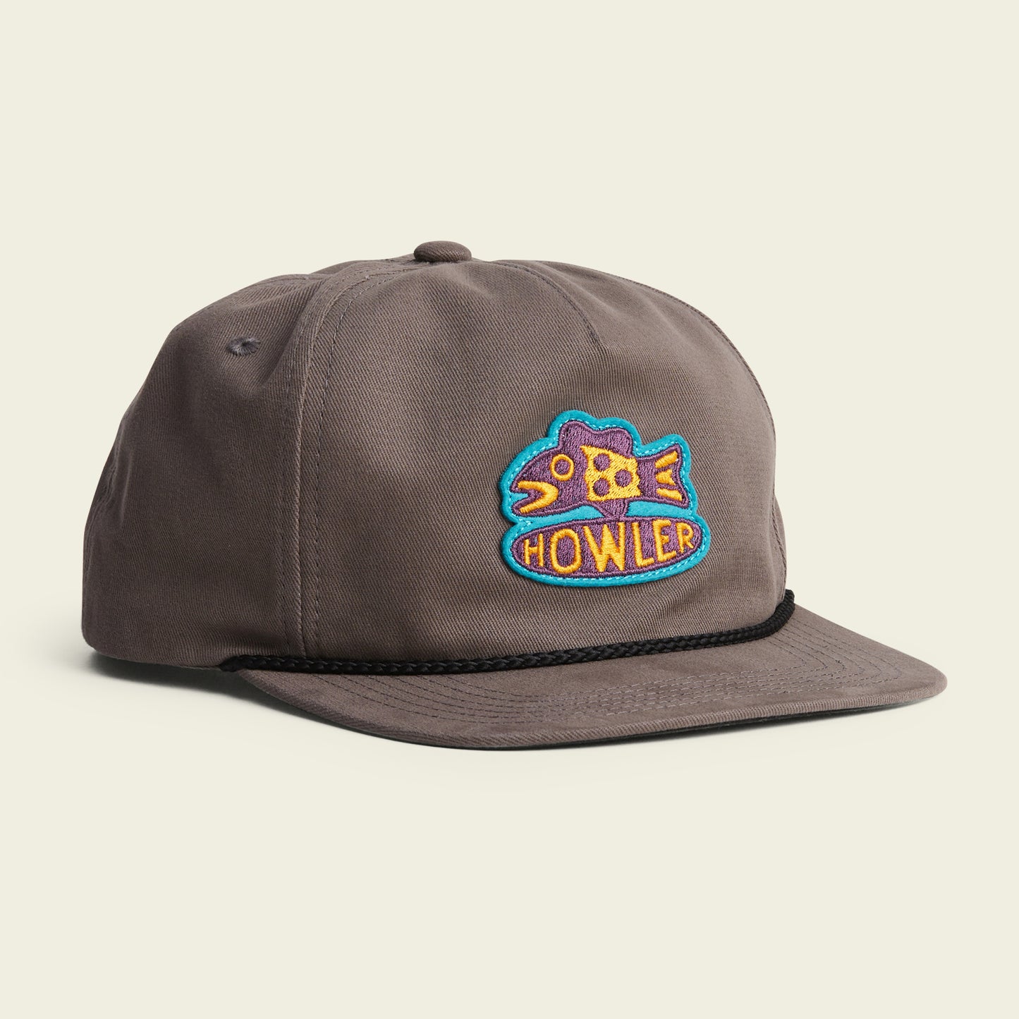 A gray baseball cap featuring a colorful embroidered fish patch with the word HOWLER on the front, a black braided rope above the brim, and an adjustable snapback closure for comfort. Part of our Unstructured Snapbacks collection. - View 2