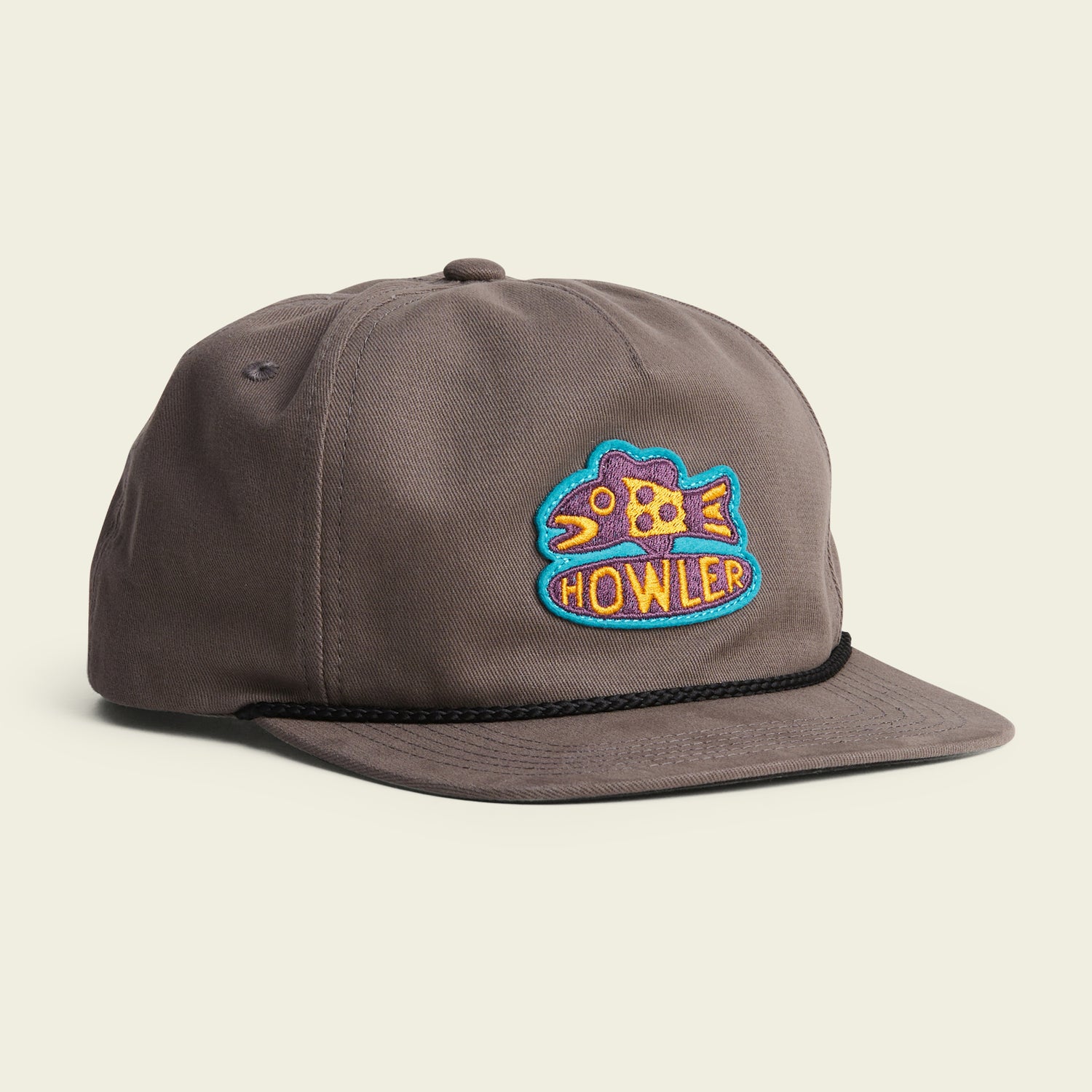 A gray baseball cap featuring a colorful embroidered fish patch with the word HOWLER on the front, a black braided rope above the brim, and an adjustable snapback closure for comfort. Part of our Unstructured Snapbacks collection.