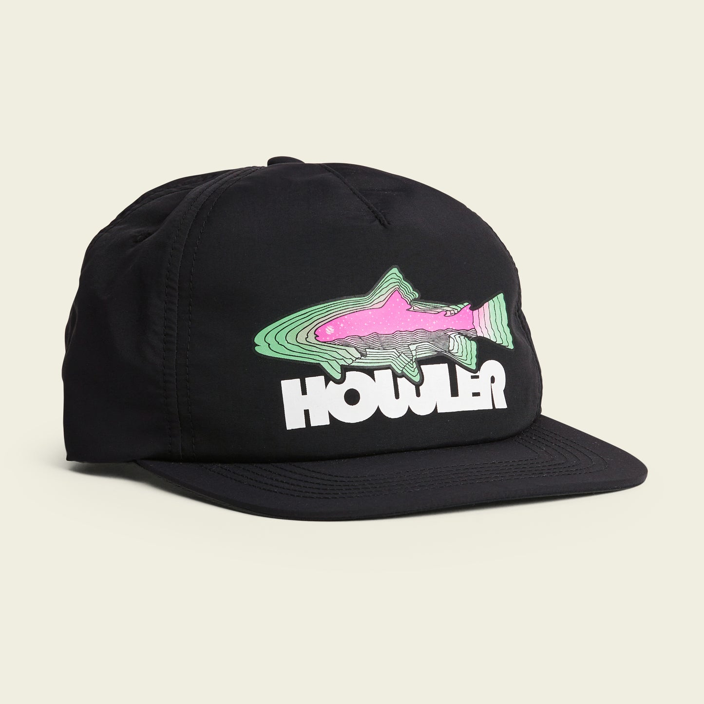 A black cap featuring a colorful fish graphic with green and pink accents above the word HOWLER in bold white letters on the front. This soft crown design includes an adjustable strapback closure for a comfortable fit. - View 1