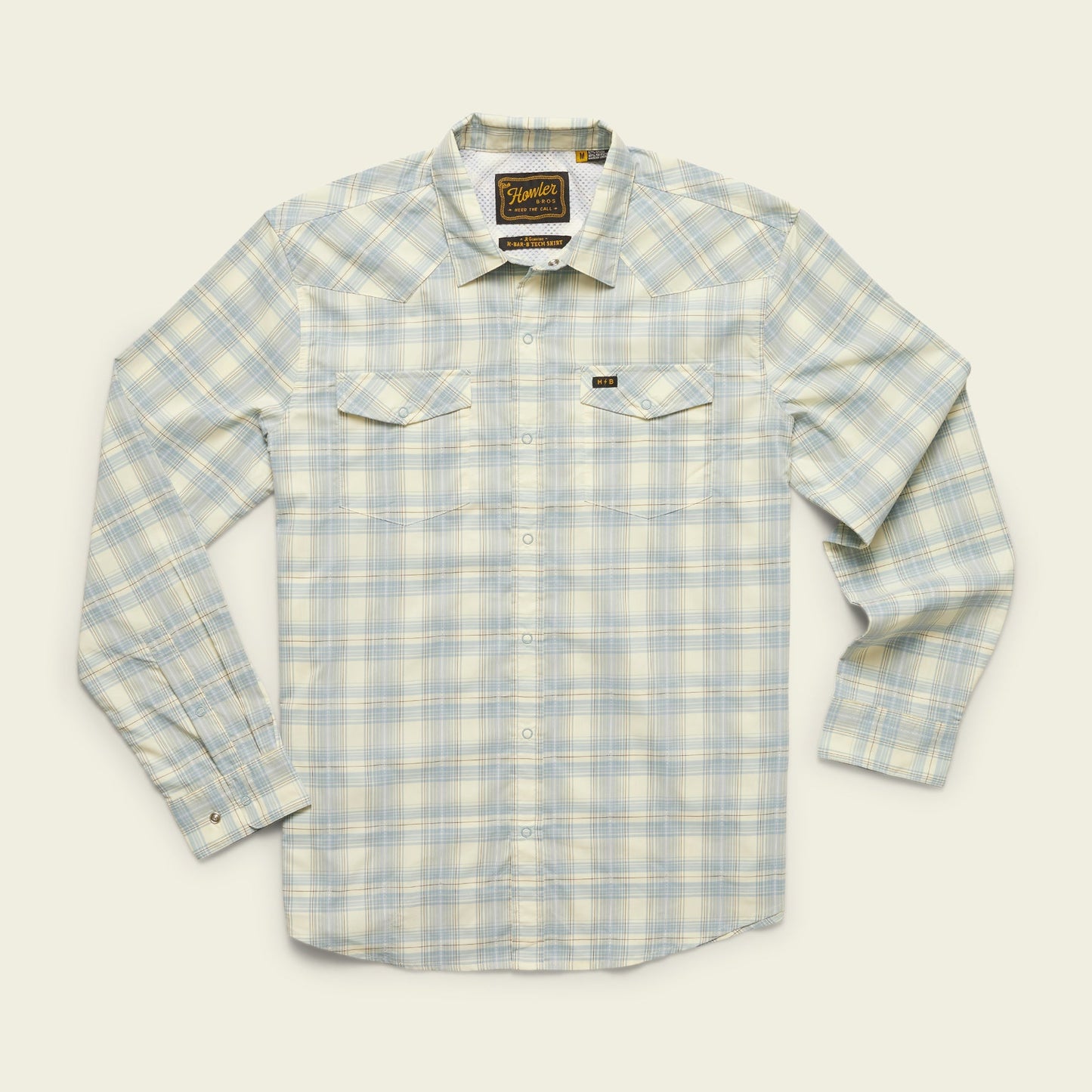 A long-sleeve, button-up plaid shirt in light blue, white, and pale yellow tones with two chest pockets and a vented rear yoke, crafted from lightweight stretch fabric, displayed on a cream background. - View 23