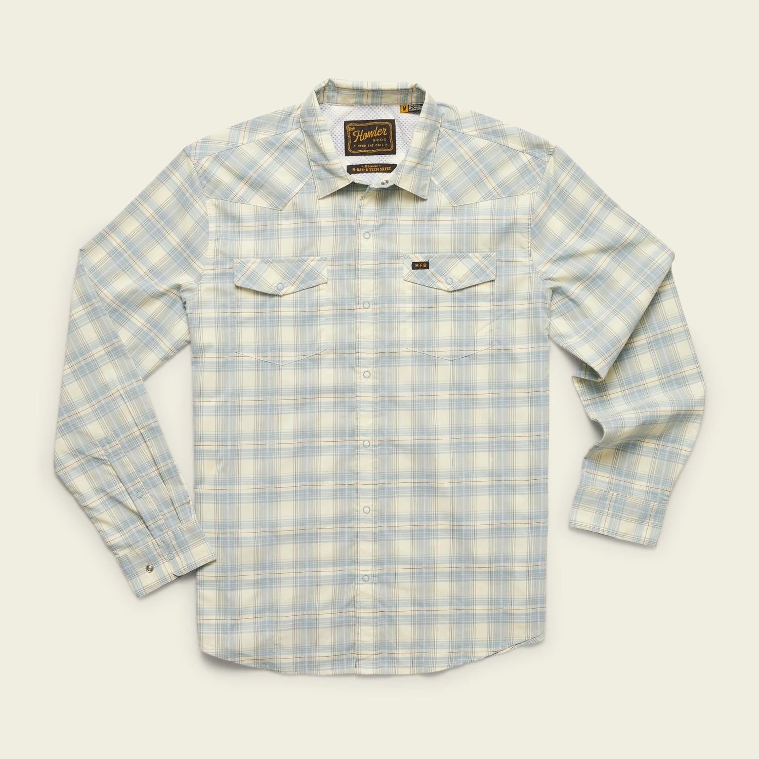 A long-sleeve, button-up plaid shirt in light blue, white, and pale yellow tones with two chest pockets and a vented rear yoke, crafted from lightweight stretch fabric, displayed on a cream background. - View 23