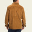 A man is shown from the back wearing a brown wide wale corduroy button-up shirt and dark pants, standing against a plain light background.