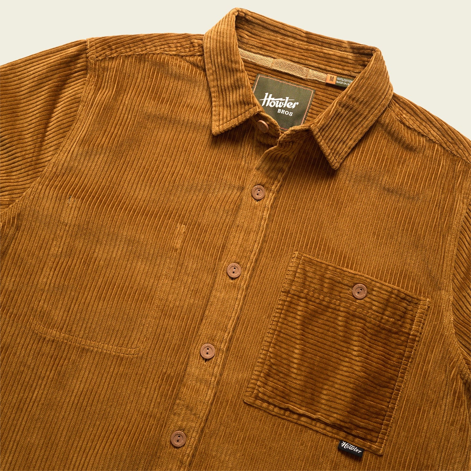 A brown wide wale corduroy button-up shirt with a collar and single chest pocket, featuring brown buttons and a visible Howler Bros label inside the neckline—perfect as an Iquitos Overshirt or travel shirt. - View 3