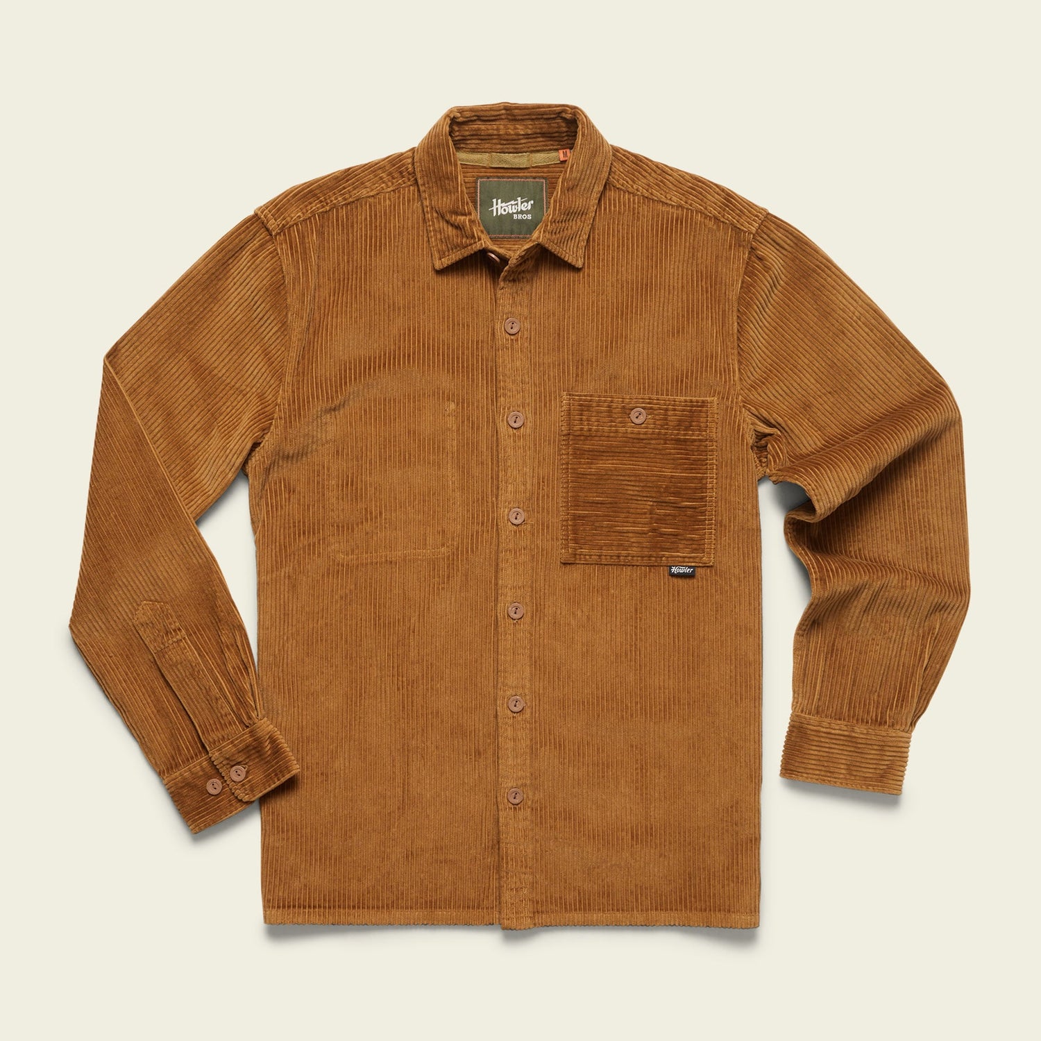 A long-sleeve, button-up brown wide wale corduroy shirt with a collar and a large front chest pocket, laid flat on a light background.