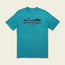 A teal short-sleeve T-shirt featuring experimental artwork: a black graphic of a mountain landscape and sun. The text reads Howler Brothers and Heed The Call, Austin, Texas, Established 2010 beneath the graphic.