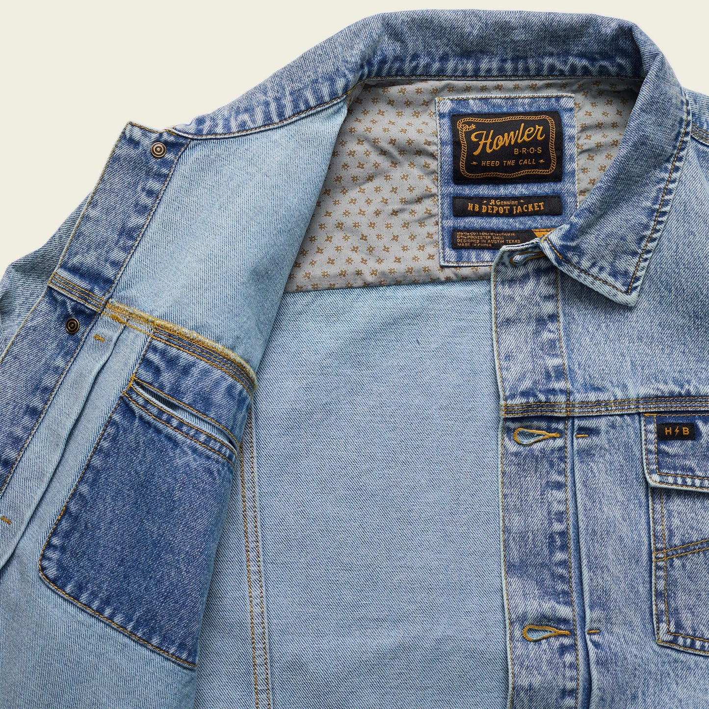 A light blue Depot Jacket with visible lightning bolt stitching, a patterned inner lining, and a Howler Bros label on the collar. The denim jacket is partially open, revealing the interior and multiple pockets. - View 4