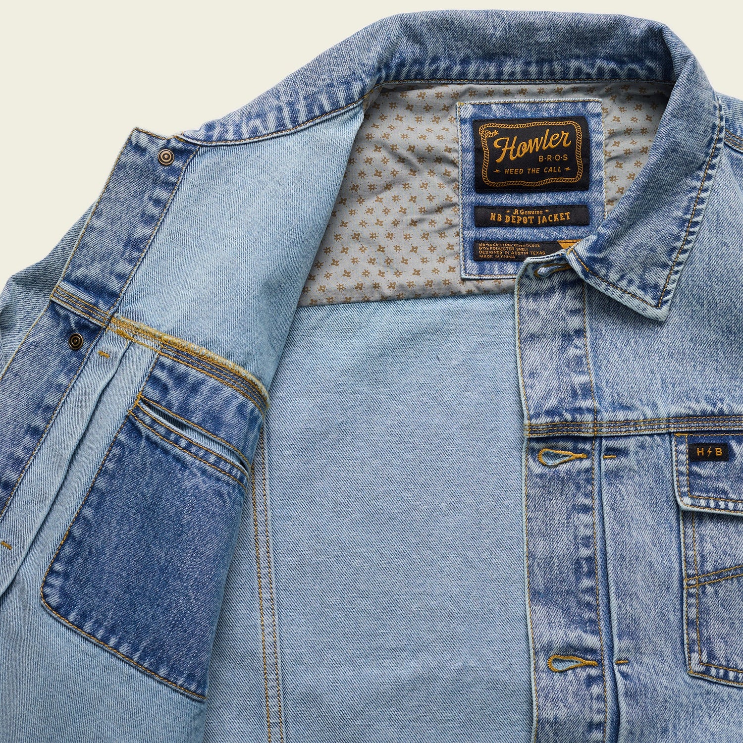 A light blue Depot Jacket with visible lightning bolt stitching, a patterned inner lining, and a Howler Bros label on the collar. The denim jacket is partially open, revealing the interior and multiple pockets. - View 4