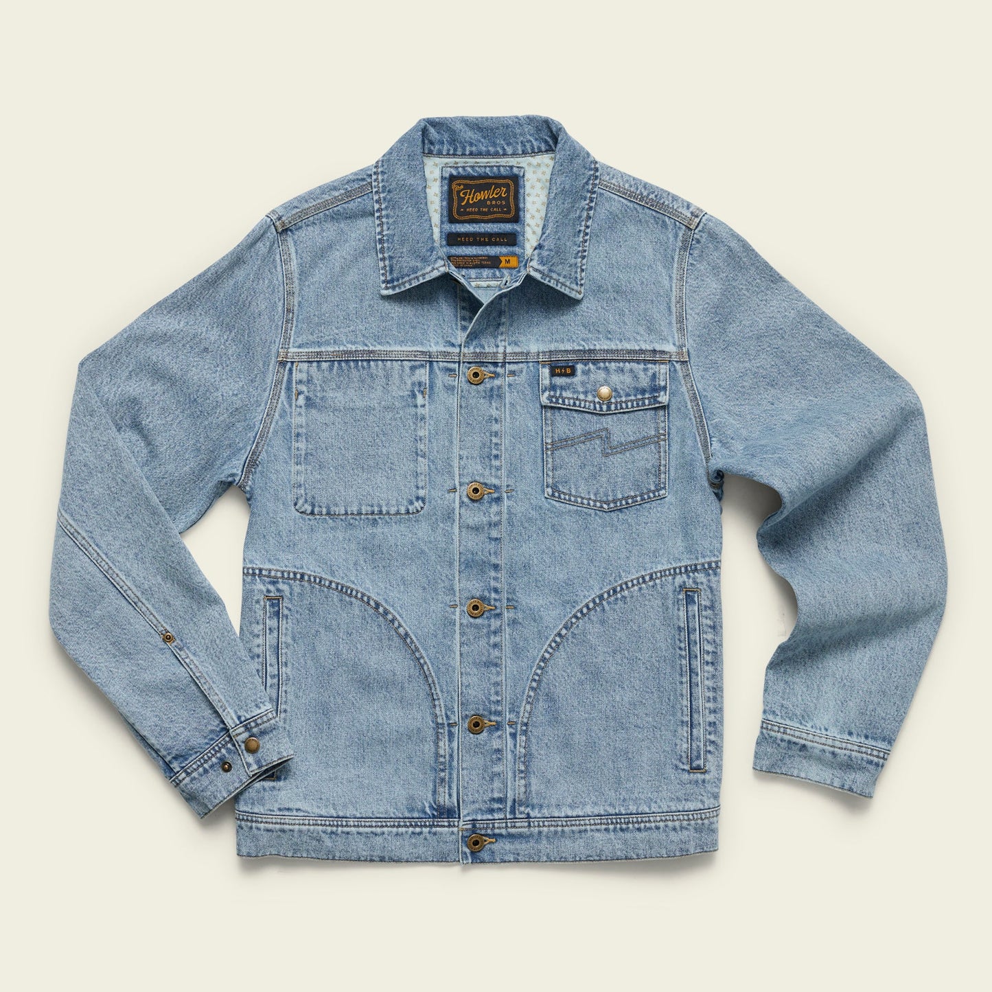 Light blue Depot Jacket denim jacket featuring brown buttons, visible lightning bolt stitch, two chest pockets (one with a button), and two large lower front pockets, laid flat on a light background. - View 1