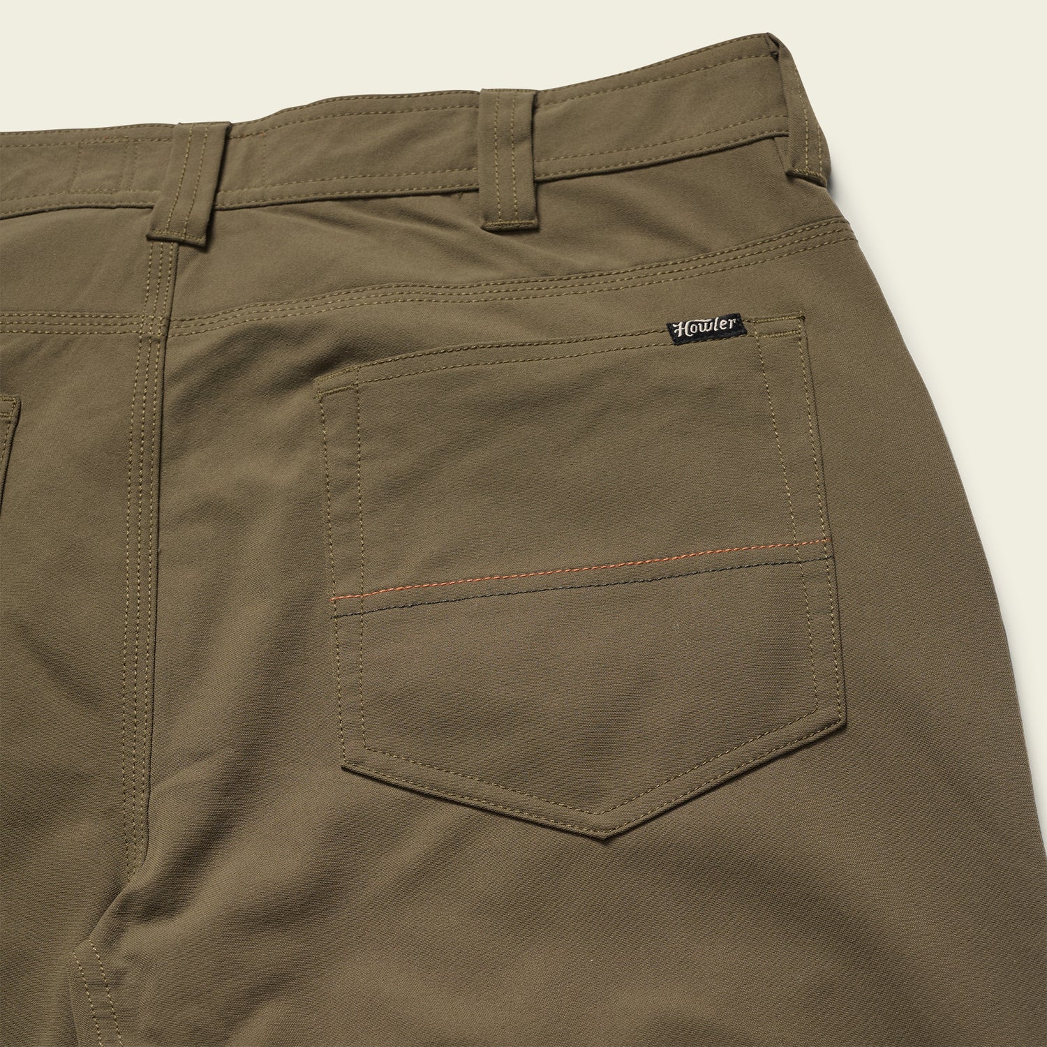 olive green Tech Pants laid out flat, showcasing the 5-pocket design. - View 3