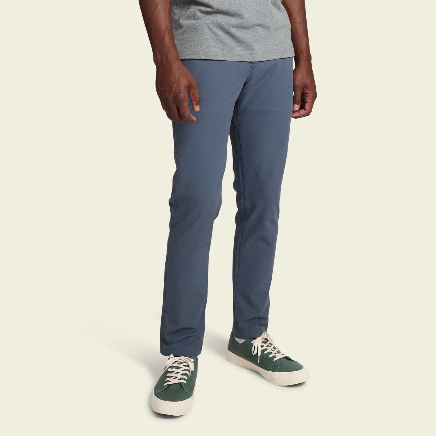 A person wearing blue Frontside Tech Pants, a gray T-shirt, and green sneakers stands against a plain light background. The photo is cropped from the shoulders down. - View 4