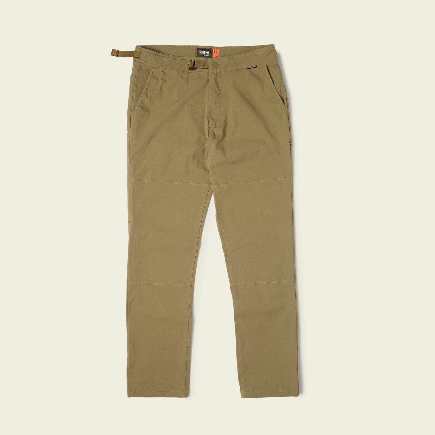 A pair of khaki-colored Trek Pants with an integrated belt, front pockets, and reinforced knee panels, designed as durable outdoor pants and laid flat on a light background. - View 3