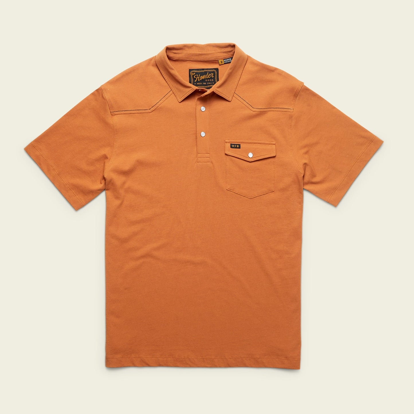 An orange Ranchero Polo, crafted from heathered cotton, features short sleeves, a collar, three buttons, and a button-flap chest pocket with a stitched label—a modern take on a western style polo. - View 1
