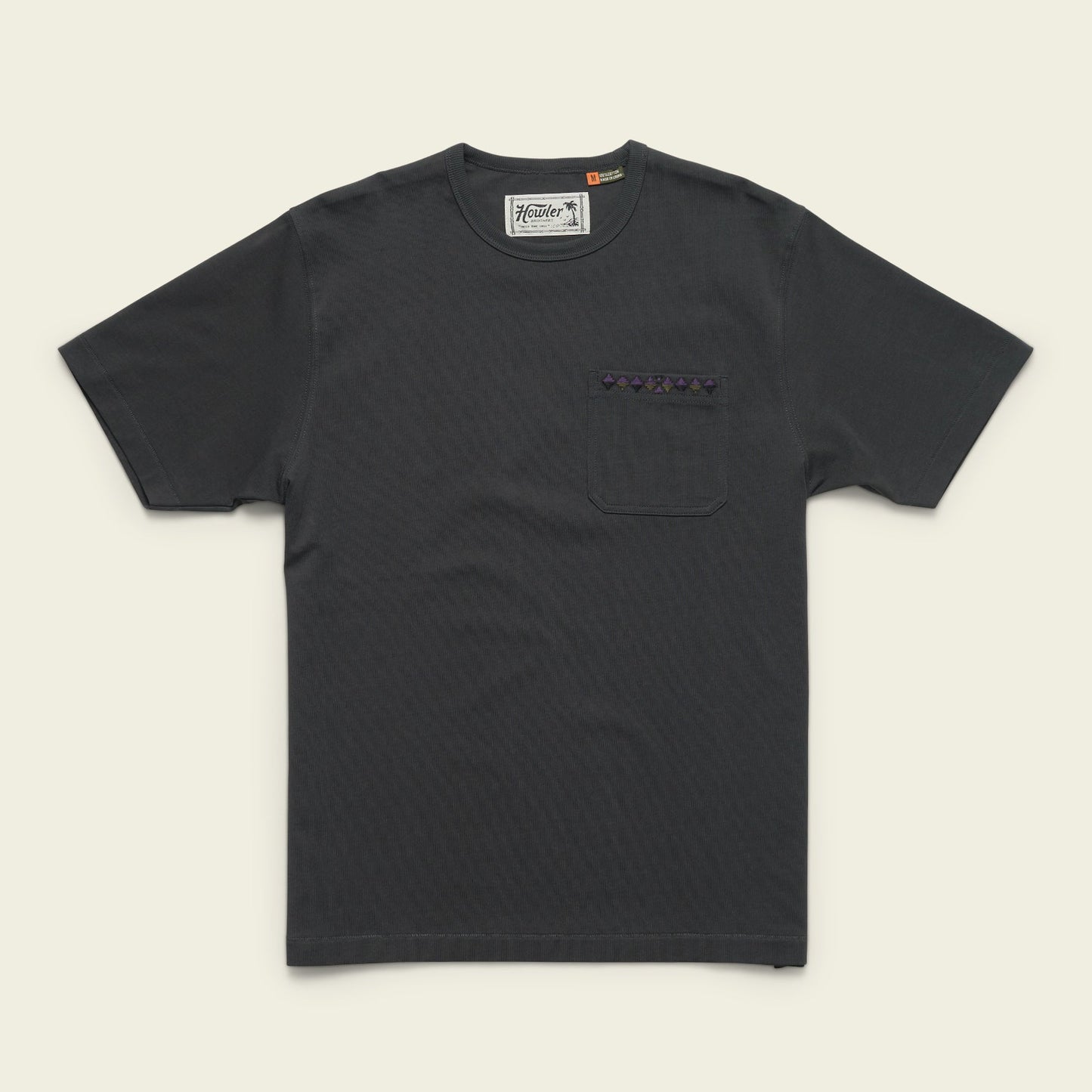 A plain black heavyweight cotton pocket t-shirt with a chest pocket featuring a small patterned strip above it, laid flat on a light background. - View 6