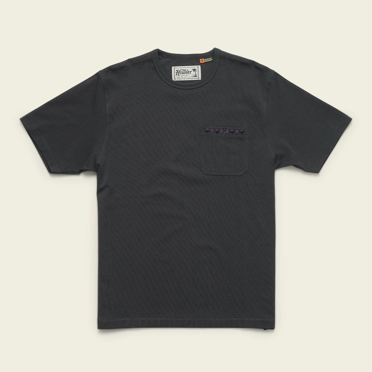 A plain black heavyweight cotton pocket t-shirt with a chest pocket featuring a small patterned strip above it, laid flat on a light background. - View 7