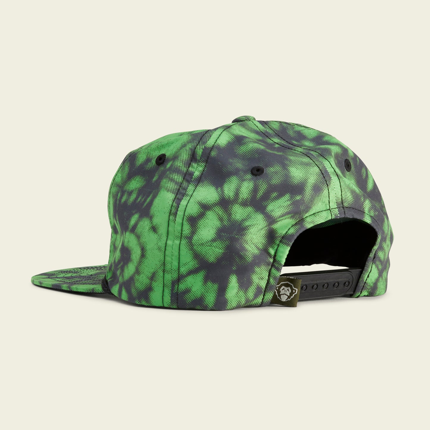 A green and black tie-dye snapback cap shown from the back, featuring an adjustable strap and a small Howler Brothers graphic logo tag next to the closure—a standout piece for snapbacks fans. - View 3