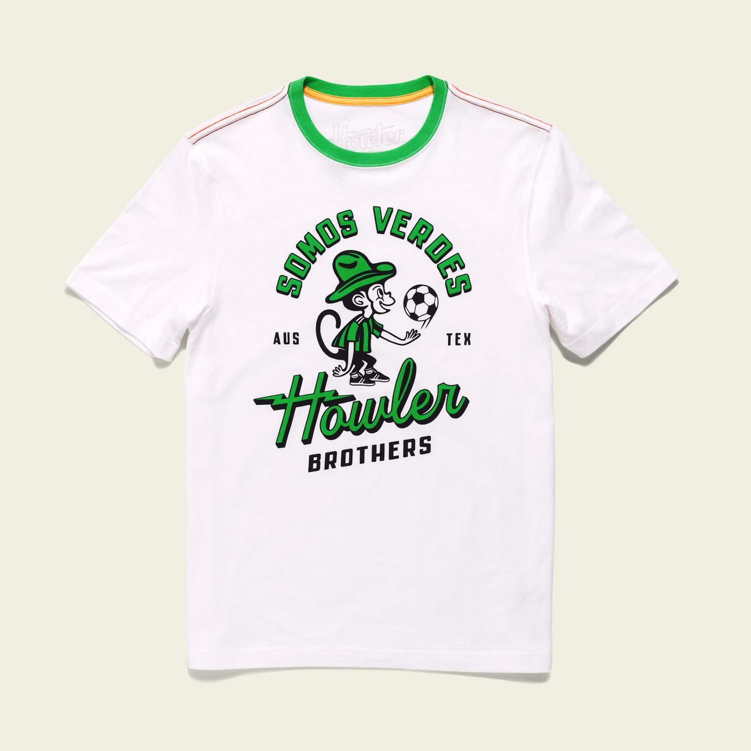 White t-shirt with green accents from the Verde Collection, featuring a cartoon monkey in a green hat holding a soccer ball. Text above reads SOMOS VERDES AUS TEX and below Howler BROTHERS—a nod to Austin FC vintage t-shirts. - View 1