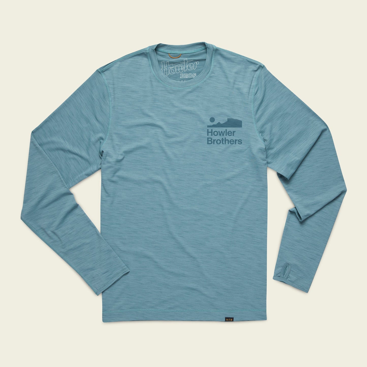 Light blue long-sleeve shirt with Howler Brothers and a howling animal graphic on the left chest. This lightweight cover up is ideal for outdoor activities and is laid flat on a plain background. - View 1