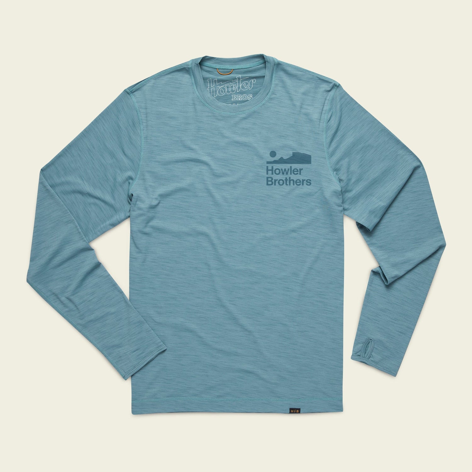 Light blue long-sleeve shirt with Howler Brothers and a howling animal graphic on the left chest. This lightweight cover up is ideal for outdoor activities and is laid flat on a plain background.