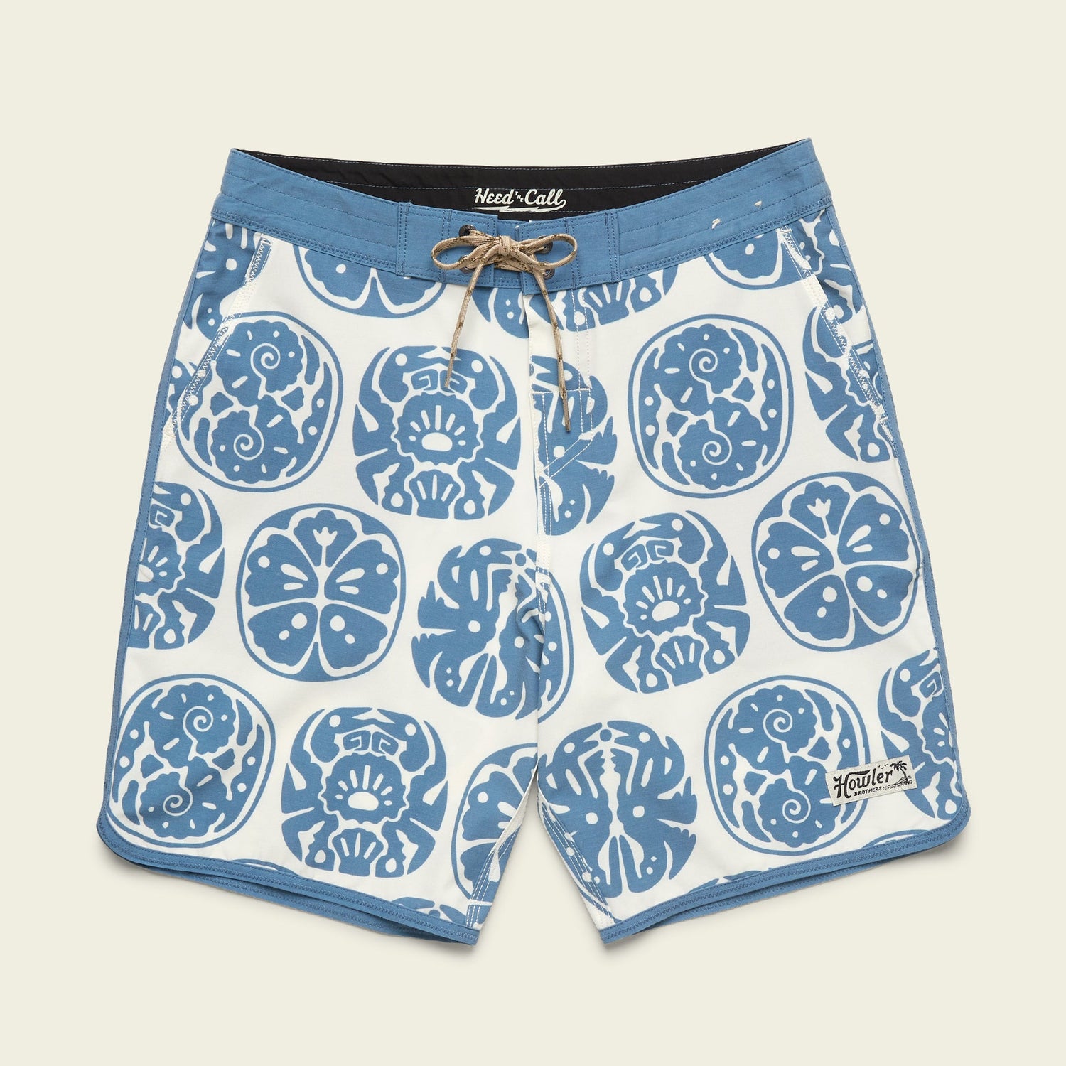 Blue and white Bruja Boardshorts with a drawstring waist, featuring abstract skulls and floral designs. Made from stretchy fabric, these board shorts have a light blue waistband, trim, and a small Howler logo near the left leg hem. - View 16