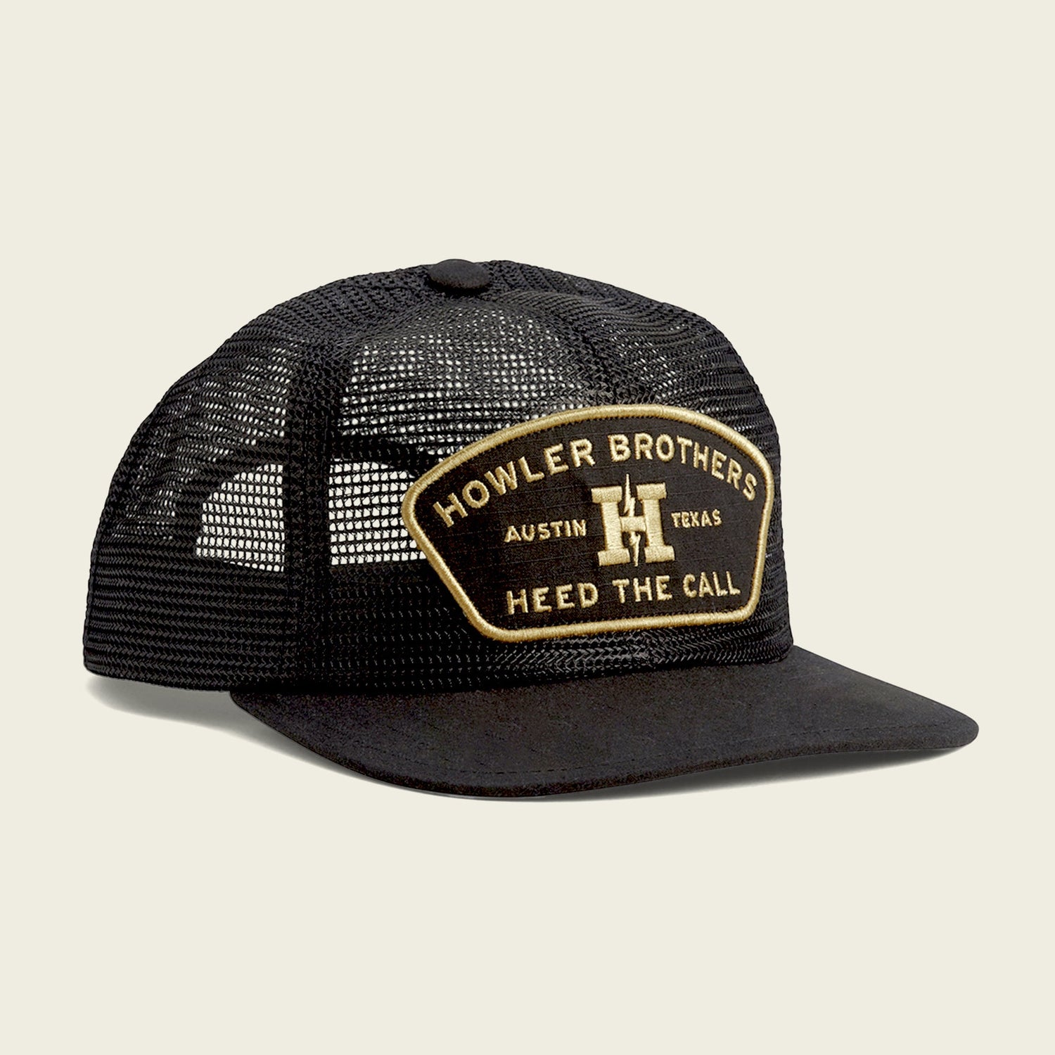 A black mesh trucker hat with a curved brim and soft crown, featuring a patch on the front that reads Howler Brothers Austin Texas Heed The Call in gold and white lettering. Includes an adjustable snapback closure for a custom fit.