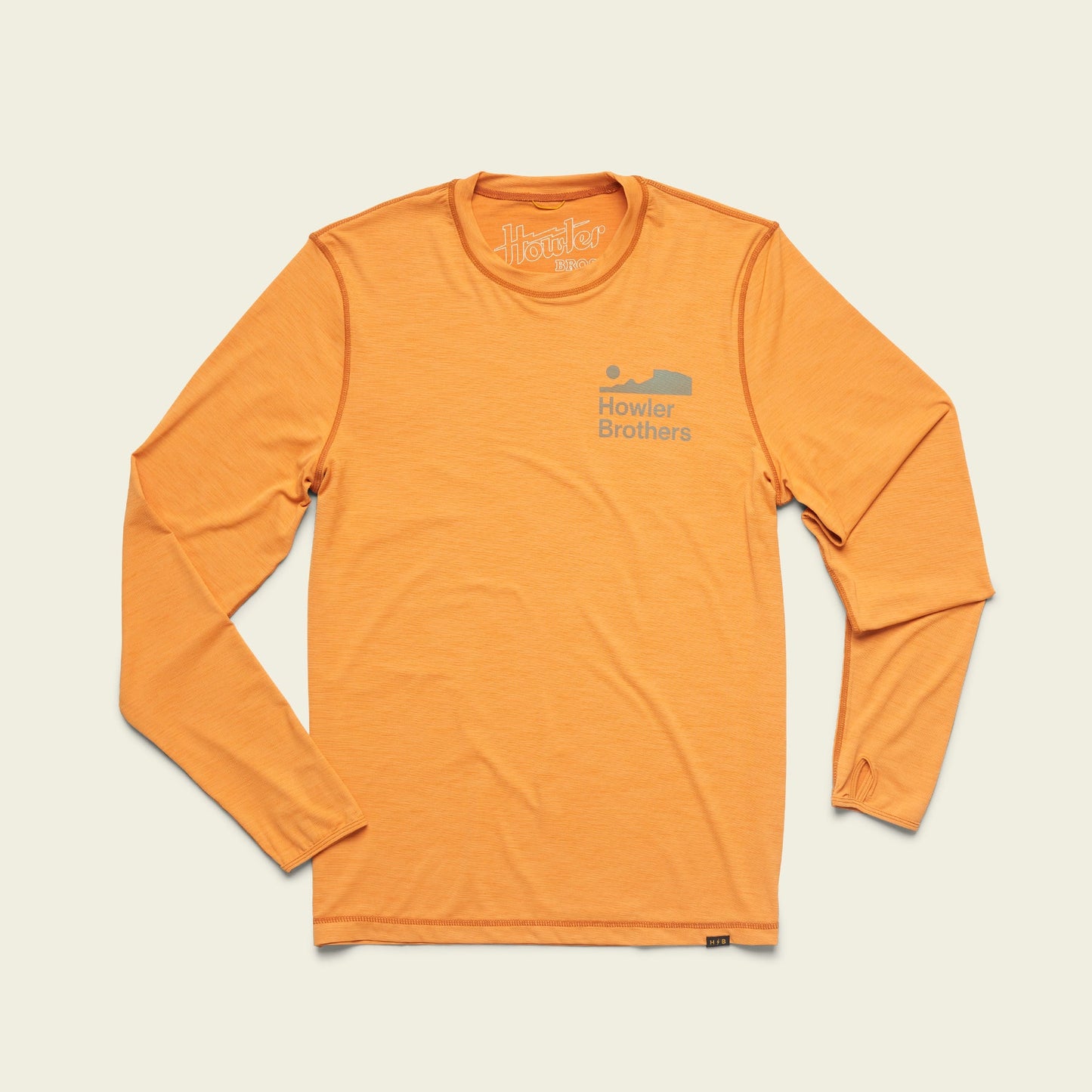 A long-sleeve, orange Howler Brothers shirt laid flat on a light background. This lightweight cover up features a small logo and text on the left chest, perfect for hiking thanks to its UPF 50+ sun protection. - View 3