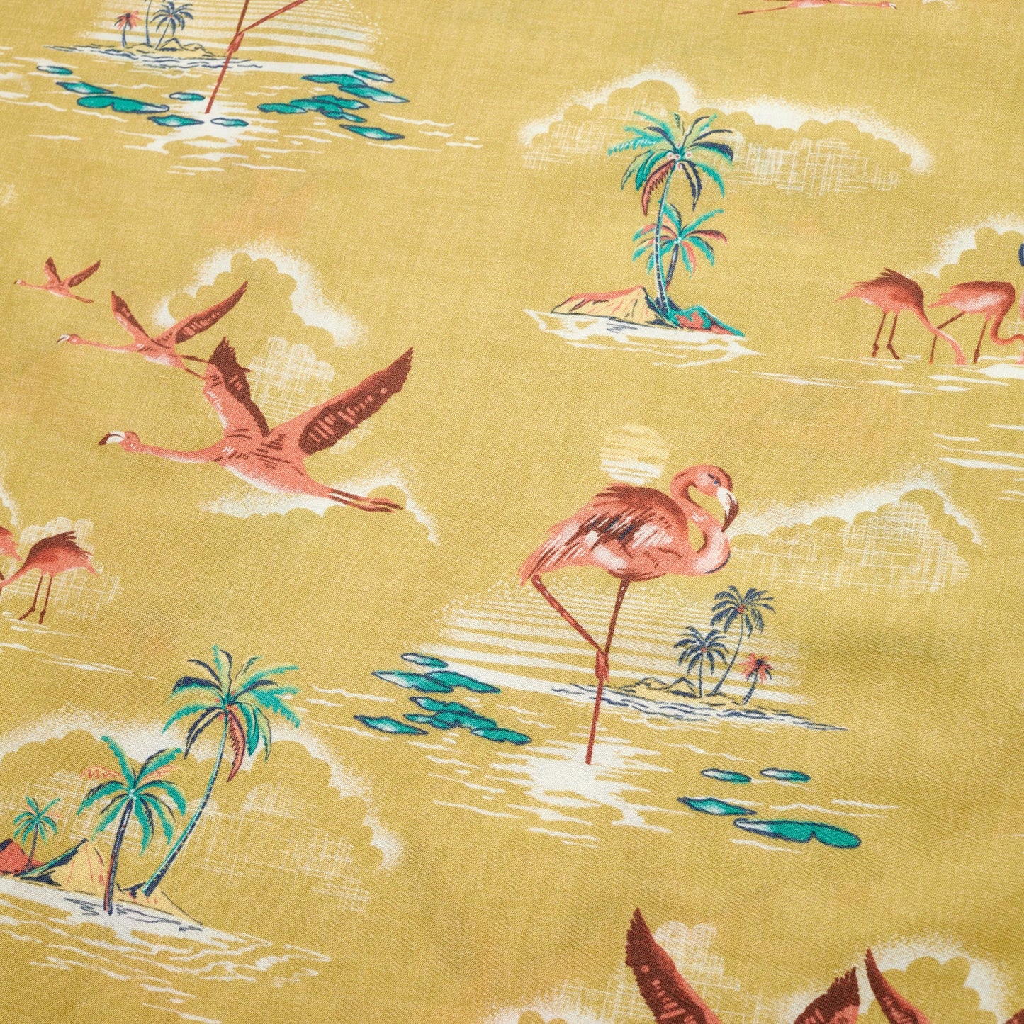 Patterned fabric for the Mansfield Shirt features pink flamingos among tropical islands and palm trees, set against a yellow background with white cloud-like details and blue water accents—showcasing unique seasonal patterns. - View 3