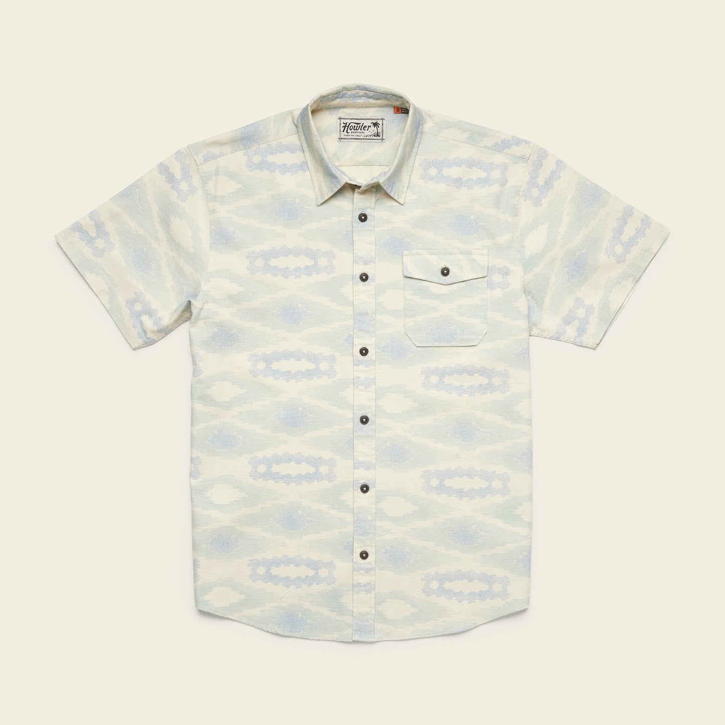 Short-sleeve button-up single pocket shirt with a pale blue and cream southwestern-inspired geometric pattern, crafted from lightweight cotton for comfort, and finished with dark buttons down the front, laid flat on a light background. - View 3