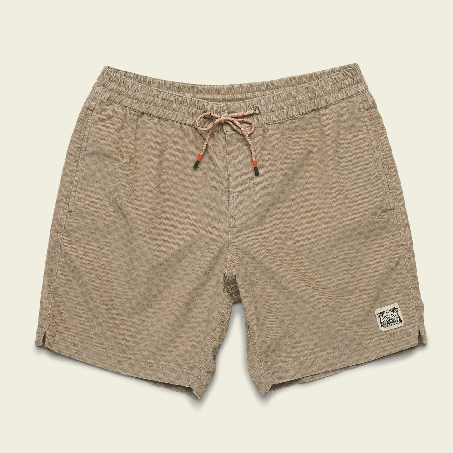 Tan patterned Pressure Drop Cord Shorts featuring an elastic waistband, drawstring, and a small palm tree patch on the left leg, crafted from stretch cotton corduroy and displayed on a plain off-white background. - View 6