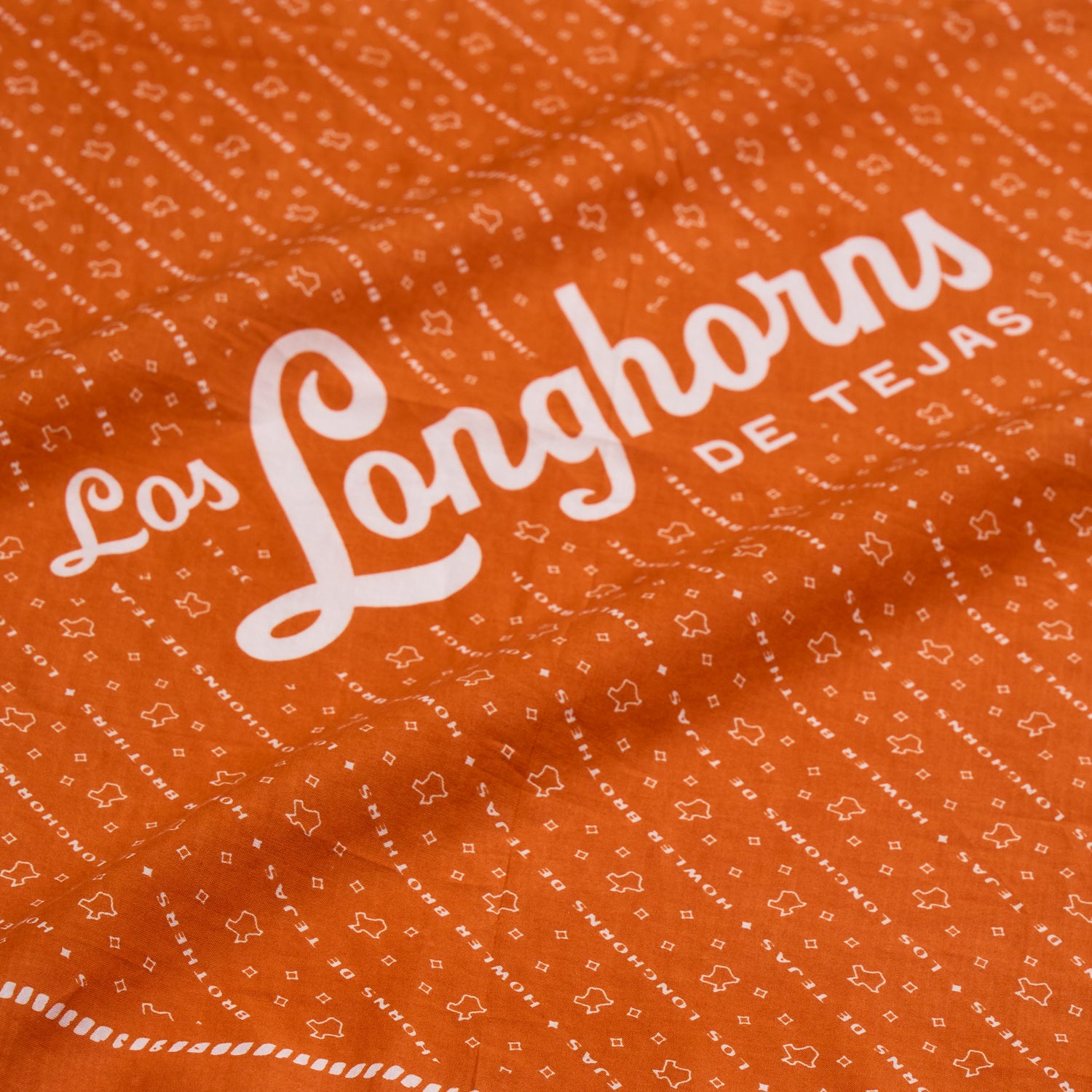 An orange Los Longhorns de Tejas Bandana with white text and small star and dot patterns—perfect as a University of Texas Longhorns game day accessory. - View 7