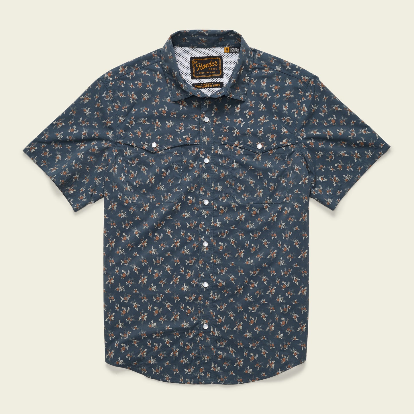 Short-sleeved, button-up technical utility shirt with a dark blue background and a small, all-over floral print. Features two chest pockets with button flaps, a patterned inner collar, and a vented rear yoke for added comfort. - View 1