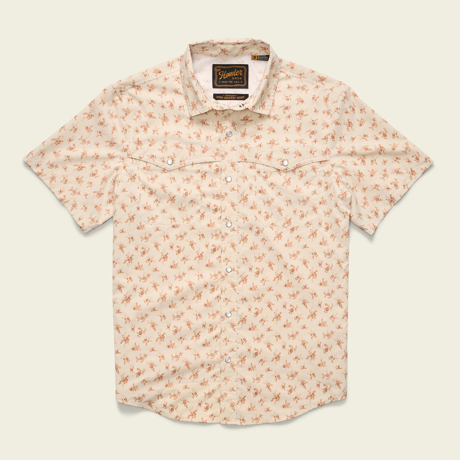 A short-sleeved, light beige button-up shirt with a small orange floral pattern, two chest pockets, pearl snaps, and a collar, crafted from nylon-poly fabric and laid flat against a plain background. - View 6