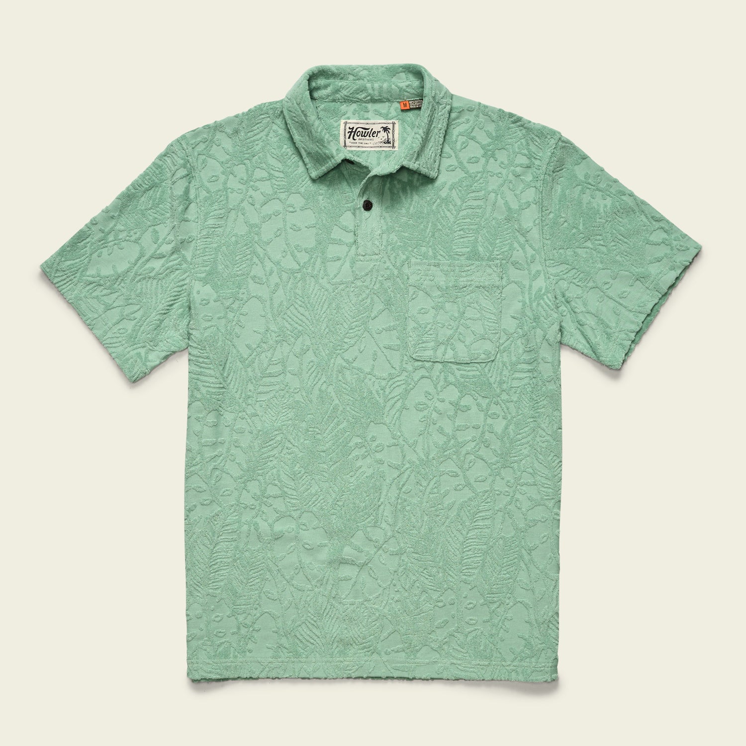 A light green soft polo with short sleeves and a subtle textured leaf pattern, featuring a single chest pocket and buttoned collar, displayed flat on a cream background. - View 2