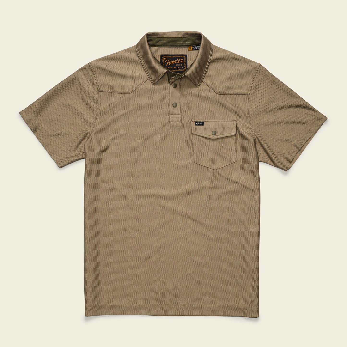 A short-sleeve, khaki-colored tech polo with a collar, three buttons, and a single chest pocket with a button flap. Made from recycled polyester, it features a subtle textured pattern and a small brand tag on the pocket. - View 1