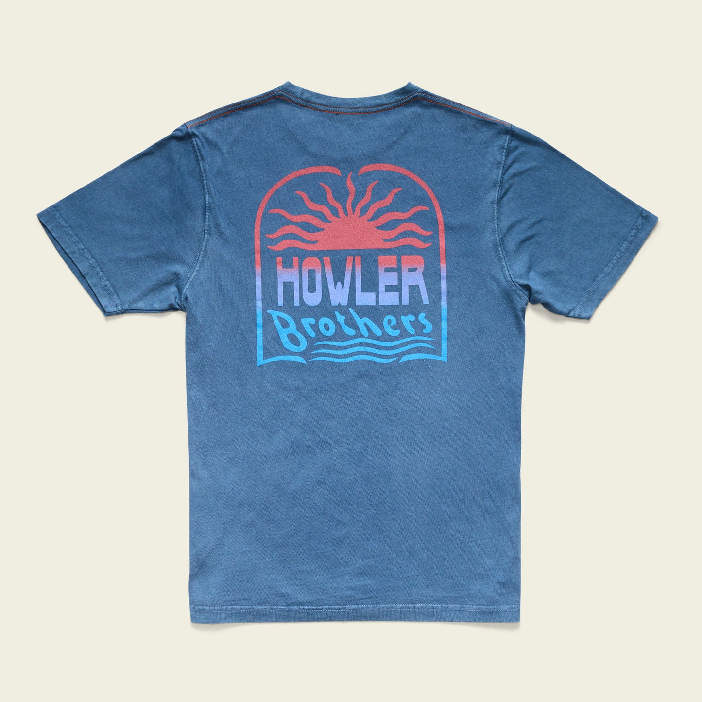 A blue cotton t-shirt featuring a graphic on the back of a setting sun with red and orange rays, above the text Howler Brothers in stylized font with wavy lines underneath, finished with a resin-washed vintage look. - View 1