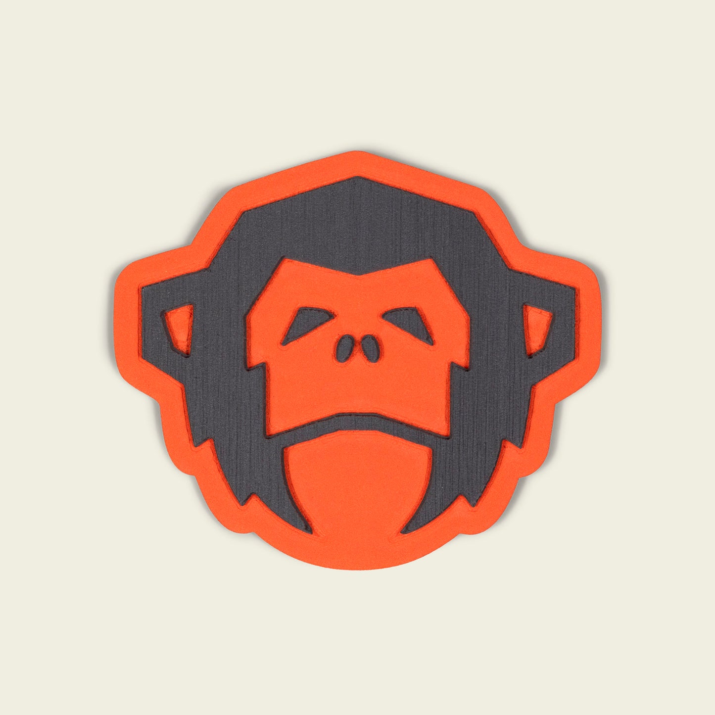 A stylized, flat illustration of a chimpanzee’s face in dark gray with an orange outline and background, set against an off-white backdrop, inspired by the resilience of industrial-strength adhesive. - View 1